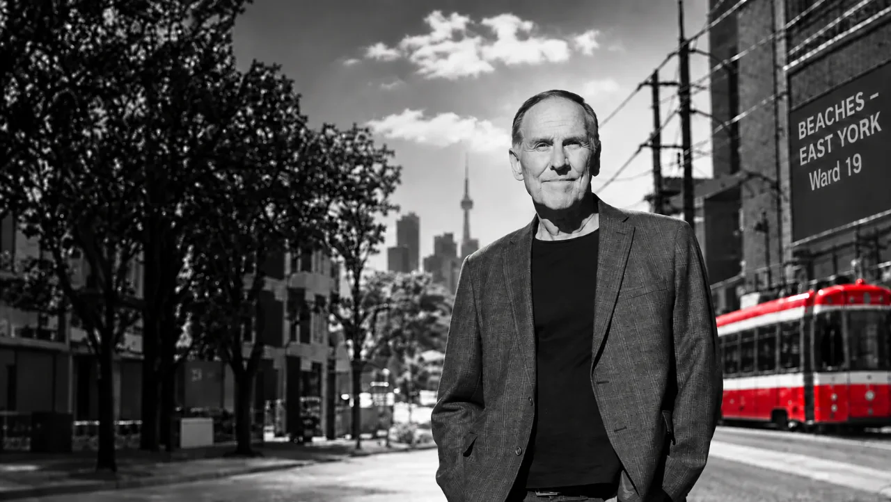 Karsten Riedel on a Beaches–East York street, Toronto skyline behind